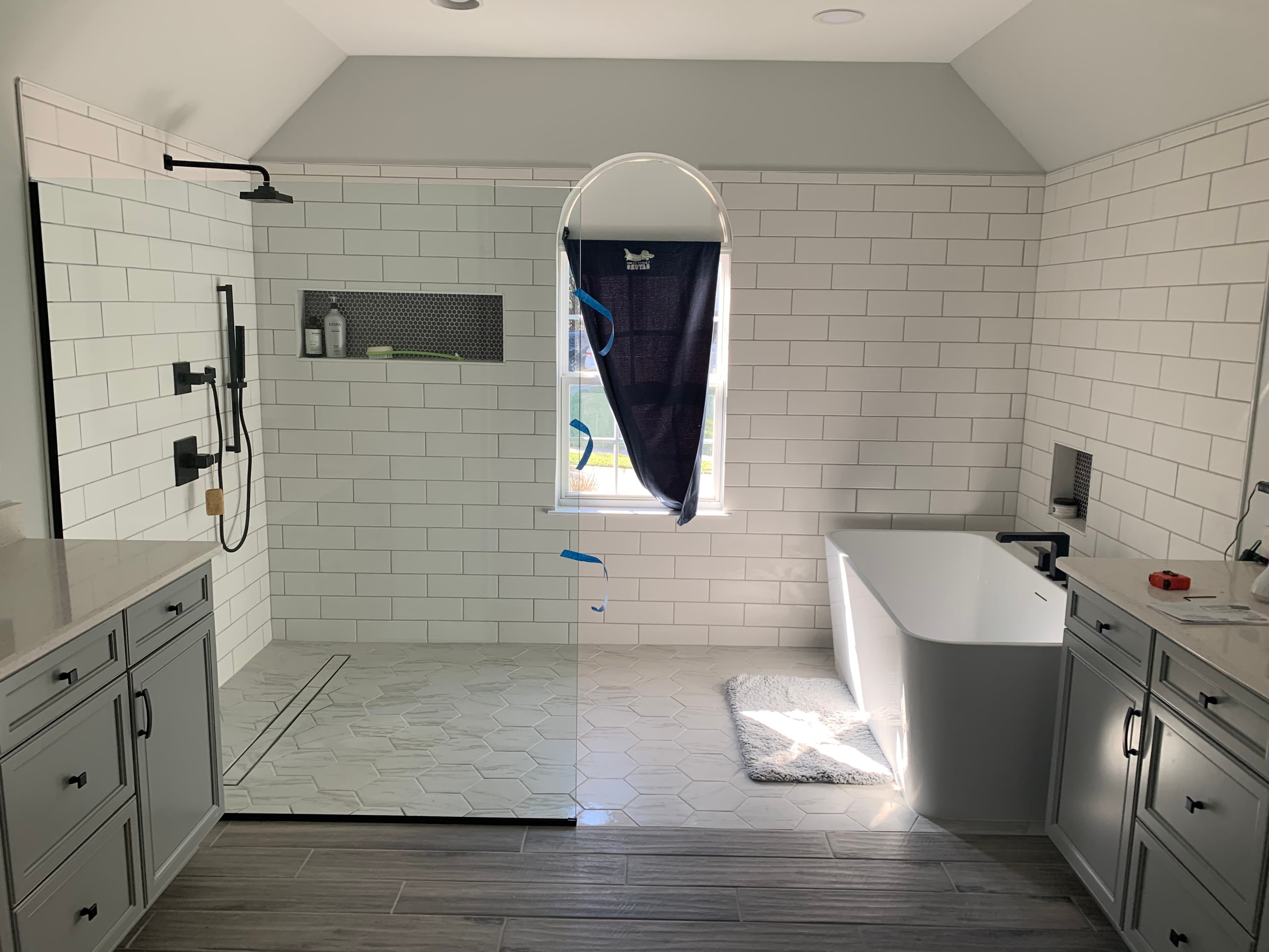 Renovated Ballantyne bathroom featuring double vanity, expanded shower, and marble surfaces